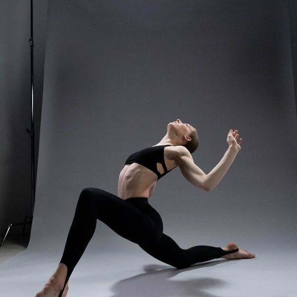 A person stretching gracefully, demonstrating flexibility achieved through yoga practice.